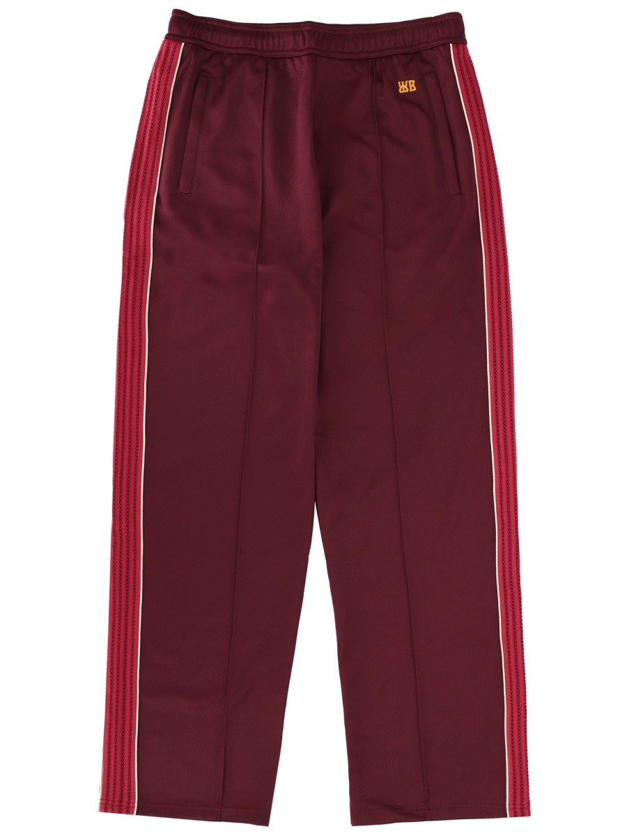 Refresh your wardrobe with the WALES BONNER unisex JOGGER PANTS in Bordeaux