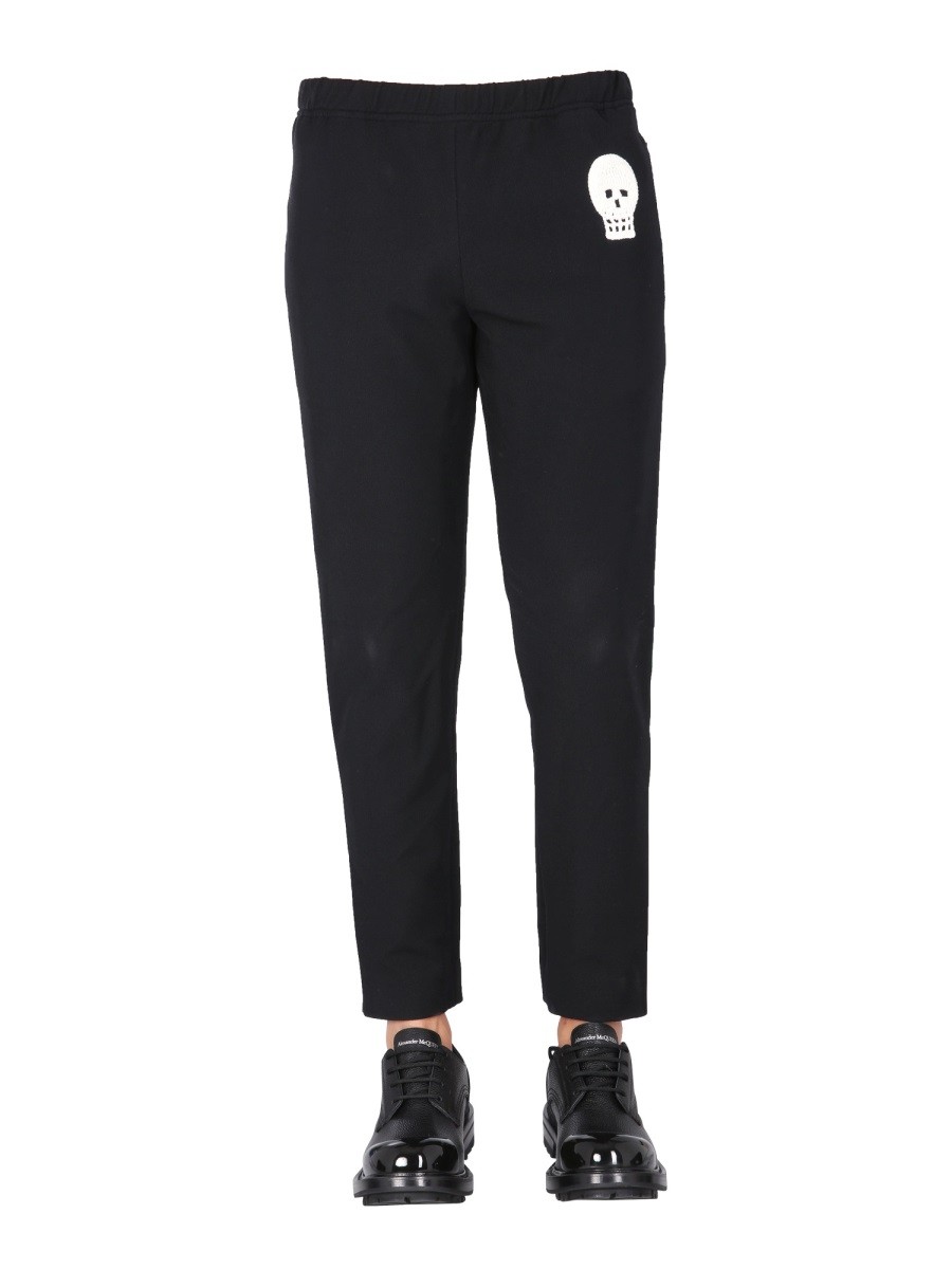 Explore the authentic Alexander Mcqueen men's JOGGING PANTS WITH EMBROIDERED SKULL in Black