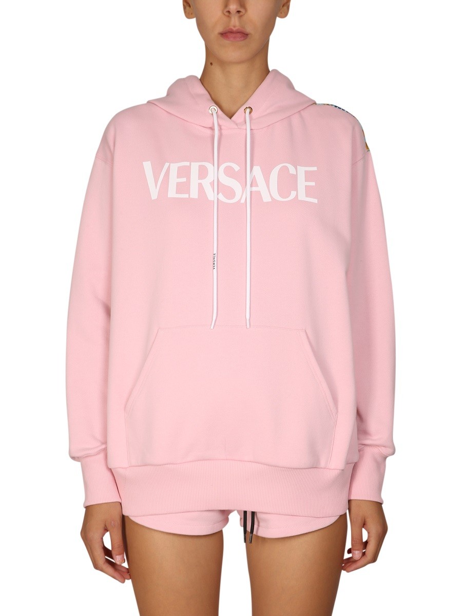 Refresh your wardrobe with the Versace women's SWEATSHIRT "THE FANS" in Pink