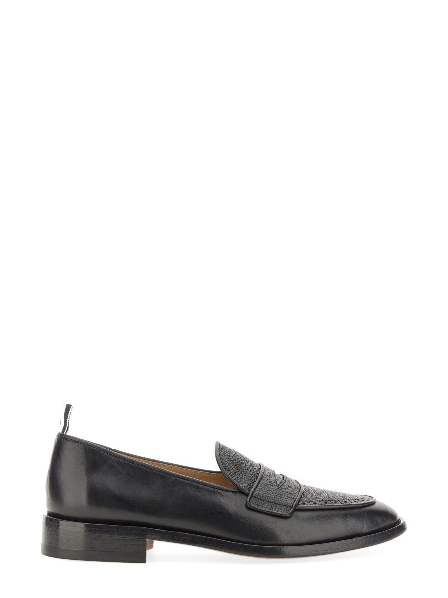 Refresh your wardrobe with the THOM BROWNE men's VARSITY PENNY LOAFER in Black